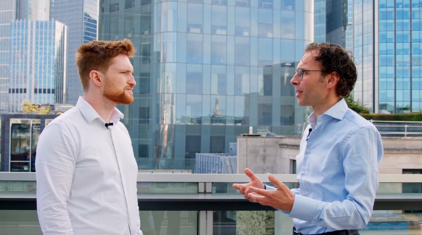 Smartly dressed professionals networking outside in a city
